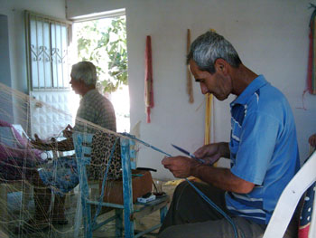 Fishermen of Akkoy are mending nets in coffee shops